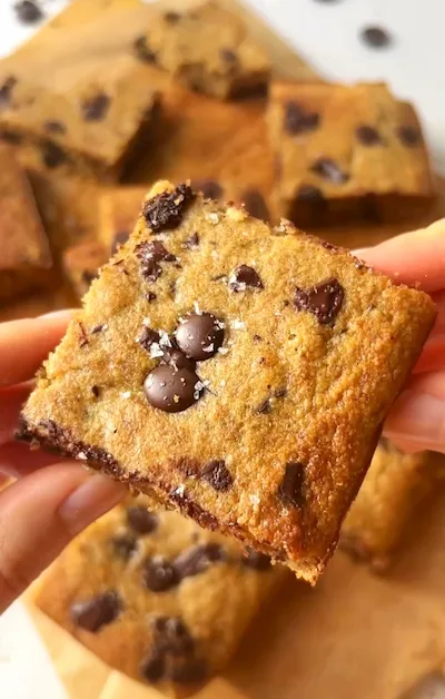 Chocolate chip banana bread bars stacked showing a moist golden crumb with melted chocolate chips