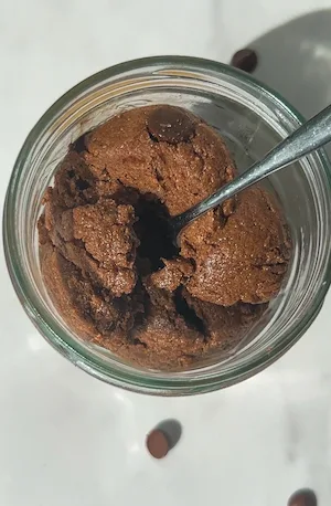 edible protein brownie batter scooped into a jar